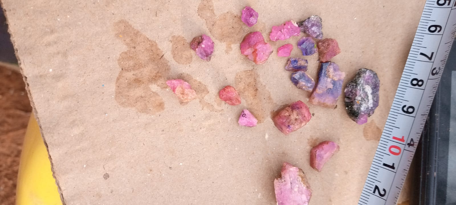 Small rough stones arranged beside a measuring tape
